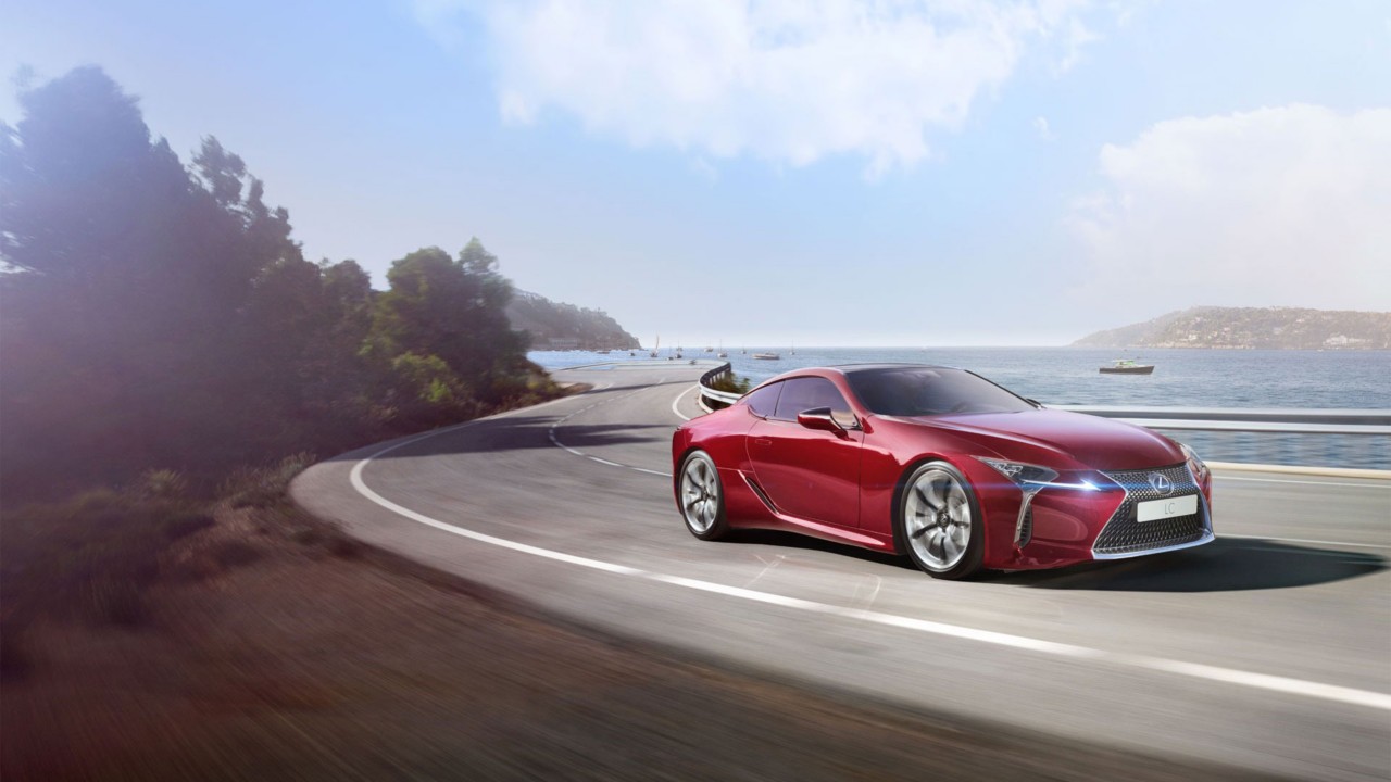 Lexus LC and LC Convertible parked in front of a racetrack 