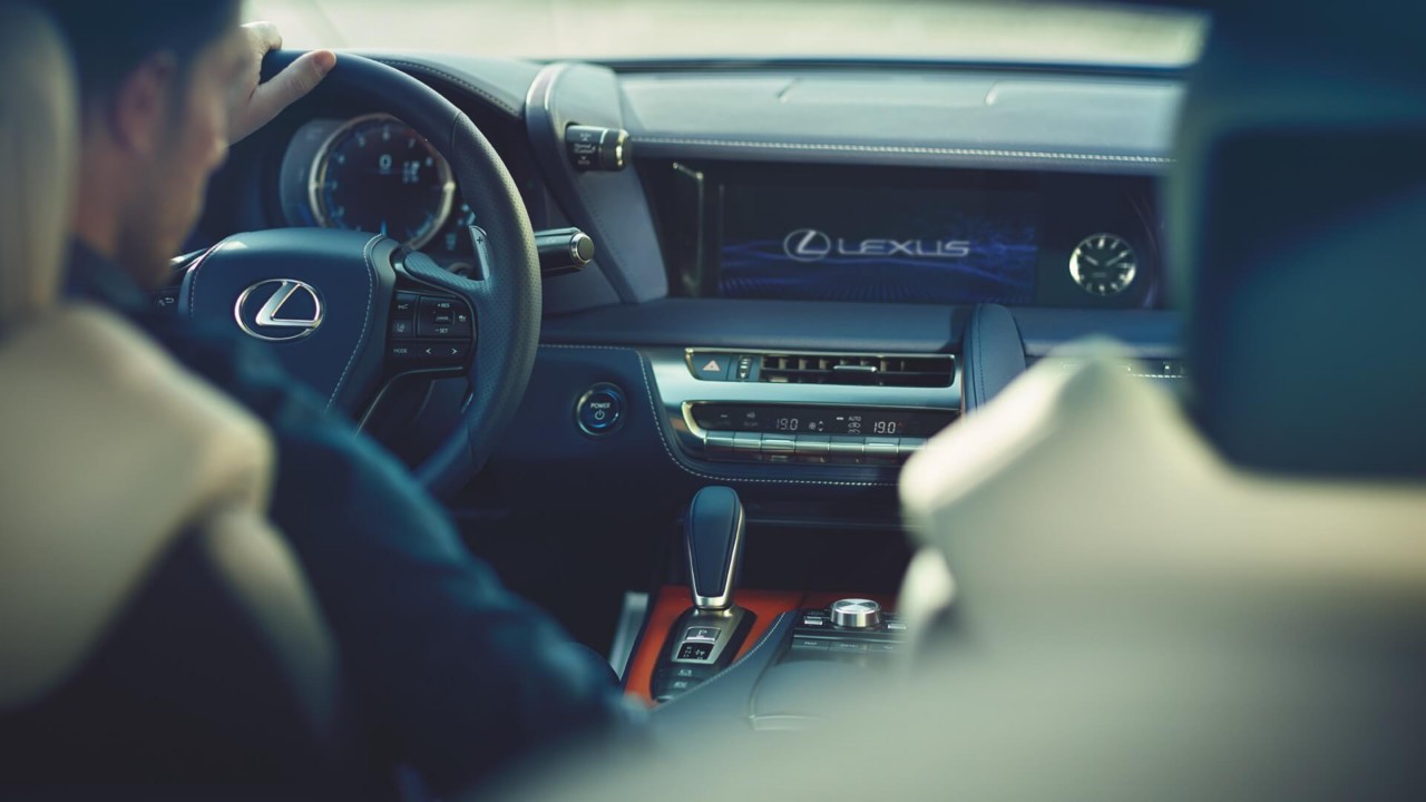 A Lexus mechanic changing a cars engine oil 