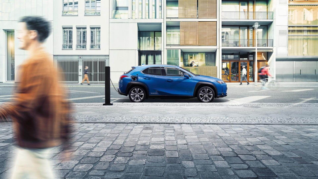 Lexus UX 300e plugged into a public charging tower 