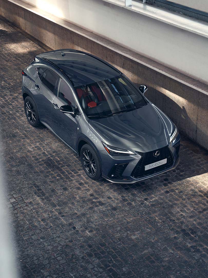 A Lexus NX driving in a coastal road 